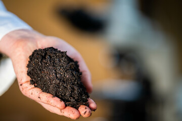 soil scientist holding a soil in a hand in a soil laboratory