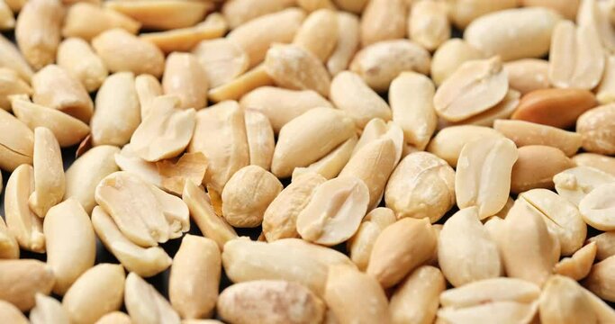Whole shelled peanut nuts kernels close-up on rotating platform
