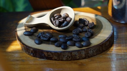 Pile of coffee beans in wooden table. Front view. Horizontal composition.