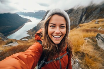 Young woman taking selfie portrait hiking mountains - Happy hiker on the top of the cliff smiling at camera