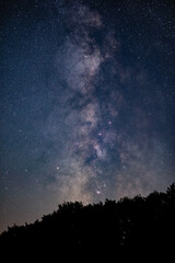 Fototapeta na wymiar Milky way stars and countryside silhouettes photographed with wide angle lens.