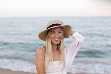 Happy beautiful young woman smiling at the beach side