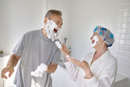 Happy loving senior married couple fooling around in bathroom - Powered by Adobe