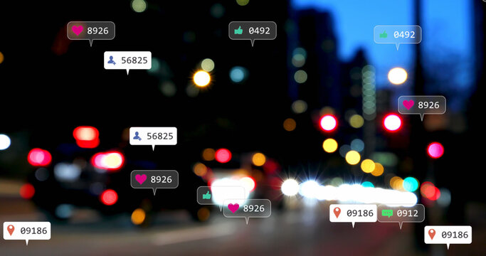 Image of social media icons and numbers over out of focus city lights