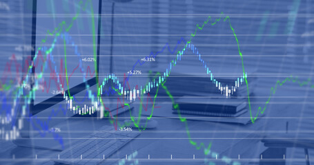 Image of financial data processing against close up of a desk at office