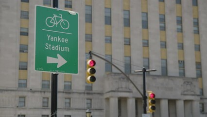 traffic light turns from yellow to red beside Yankee Stadium bike sign in Bronx