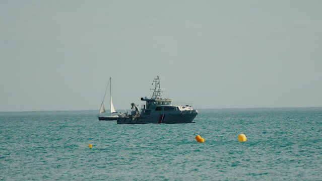 Slow motion shot of a French Navy Warship coming into dock at the Palavas les flot airshow