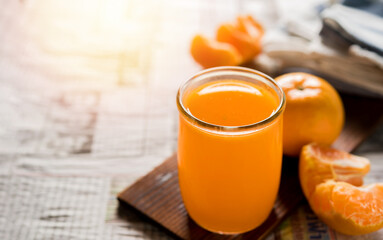 glass of fresh orange juice with fresh fruits on wooden table, high Vitamin C, orange drink