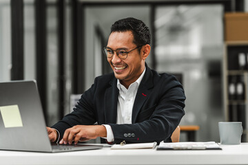 Handsome Asian businessman of Indian descent working at desk, digital asset exchange license, the world's largest cryptocurrency exchange by trading volume, registered recognized market operators