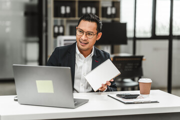 Handsome Asian businessman of Indian descent working at desk, digital asset exchange license, the world's largest cryptocurrency exchange by trading volume, registered recognized market operators