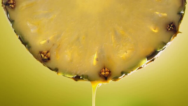 Flowing Pineapple Juice from Pineapple slice, macro shot in slow motion