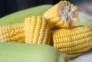 Fresh corn on rustic white wooden table, closeup