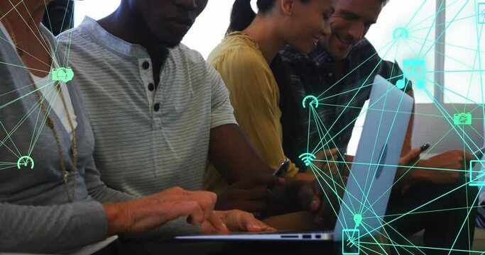 Animation of connected icons forming globes over diverse coworkers discussing reports on laptop