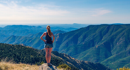 Hiker woman standing on peak enjoying panoramic view of mountain range ( Mont aigoual in France)- Hiking, successful,achievement concept