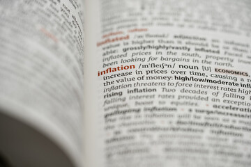 Obraz premium close up of a dictionary with the definition of word inflation