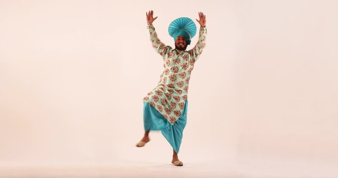 Sikh man doing bhangra dance during Baisakhi celebration