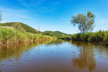 Massaciuccoli lake (Lago di Massaciuccoli) with green reeds, nature reserve and natural landmark in...
