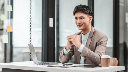 Asian business asian man supervisor analyse financial report of responsible worker pay attention on...