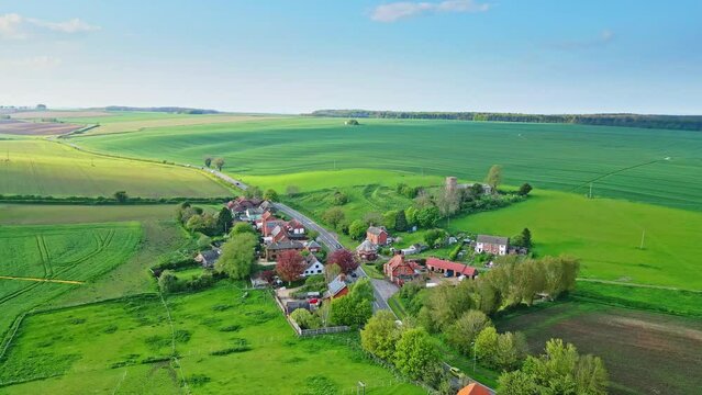 Drone imagery exhibits Burwell village, former medieval market town—surrounded by country fields, classic red brick homes, and the abandoned Saint Michael parish church on Lincolnshire's Wold Hills.