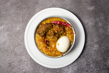 Beef dal Khichuri with boiled egg served in dish isolated on background top view of bangladesh food