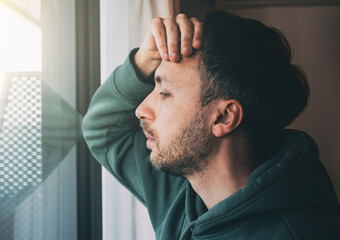 Tired man looks at window. Sad Middle-age person in life crisis or problems. Work depression or business bankruptcy concept. - obrazy, fototapety, plakaty