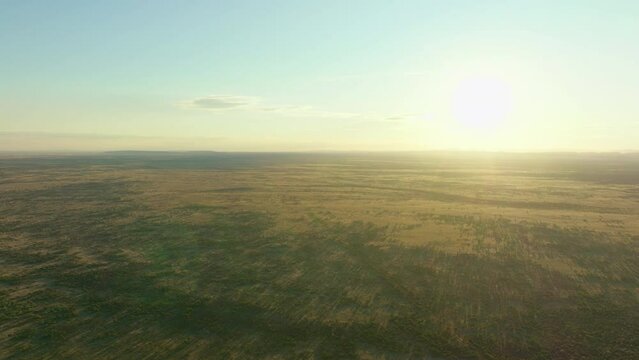 High Aerial Drone Flyover Alice Springs Simpson Desert Arid Australian Outback Landscape With Sun On Horizon 4K
