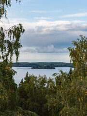 View of a peaceful lake through trees in Kangasala, Finland