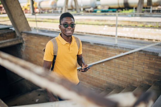 Young man with headphones and mobile phone on the train station