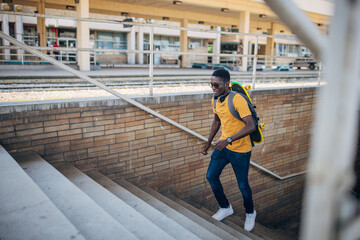Young man with skateboard waiting for train