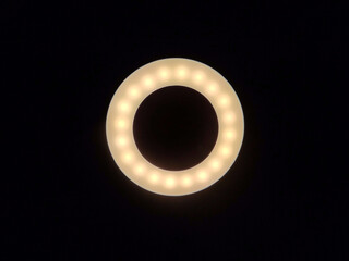 Ring-shaped warm white LED lights illumination against a dark backdrop