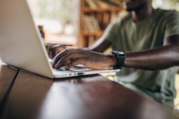 Young man studying on the laptop in the park