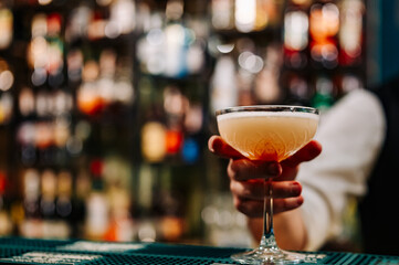 man hand bartender making cocktail in glass on the bar counter