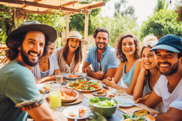 Happy multiracial many generations of family celebrating together at summer outdoor party barbecue.