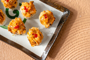 sushi is a Japanese dish of prepared vinegared rice, usually with some sugar and salt, accompanied by a variety of ingredients such as seafood, often raw and vegetables.