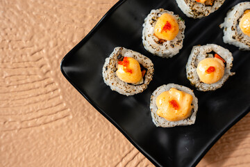 sushi is a Japanese dish of prepared vinegared rice, usually with some sugar and salt, accompanied by a variety of ingredients such as seafood, often raw and vegetables.