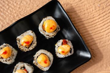 sushi is a Japanese dish of prepared vinegared rice, usually with some sugar and salt, accompanied by a variety of ingredients such as seafood, often raw and vegetables.