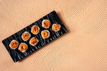 sushi is a Japanese dish of prepared vinegared rice, usually with some sugar and salt, accompanied by a variety of ingredients such as seafood, often raw and vegetables.