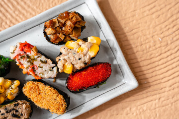 sushi is a Japanese dish of prepared vinegared rice, usually with some sugar and salt, accompanied by a variety of ingredients such as seafood, often raw and vegetables.