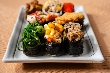 sushi is a Japanese dish of prepared vinegared rice, usually with some sugar and salt, accompanied by a variety of ingredients such as seafood, often raw and vegetables.