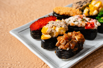 sushi is a Japanese dish of prepared vinegared rice, usually with some sugar and salt, accompanied by a variety of ingredients such as seafood, often raw and vegetables.