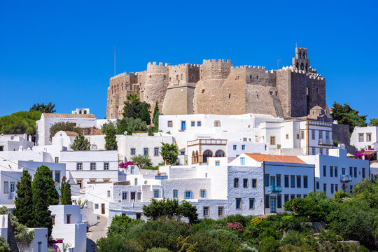 The three windmills of Chora and iconic Monastery of Saint John the Theologian in chora of Patmos island, Dodecanese, Greece