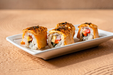 sushi is a Japanese dish of prepared vinegared rice, usually with some sugar and salt, accompanied by a variety of ingredients such as seafood, often raw and vegetables.