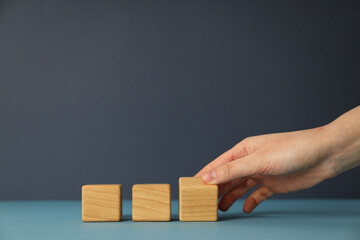 Wooden cubes on a dark background, bipolar disorder concept, place for text