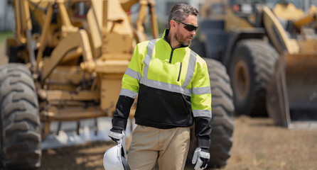 Worker with bulldozer on site construction. Man excavator worker. Construction driver worker with...