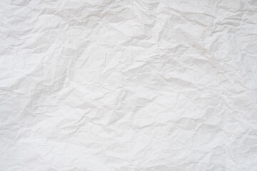 Wrinkled or crumpled white stencil paper or tissue after use in toilet or restroom with large copy space used for background texture in decorative art work.