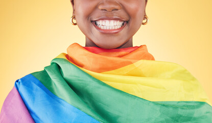 Woman, mouth closeup and rainbow flag in studio for smile, teeth or happy for inclusion by yellow...