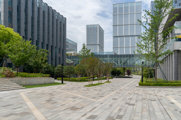 empty concrete floor in front of modern buildings in the downtown street.