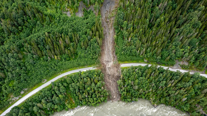 Aerial shot of big river and landslides during flood