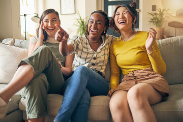 Happy, friends and women watching tv on a sofa laughing, bond and relax in their home on the weekend. Television, movie and people with diversity in living room for streaming, film or comedy in house