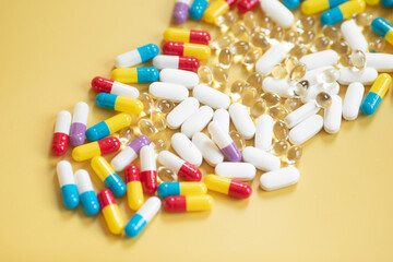 Medical pills on a yellow background. Pharmaceutical concept. 